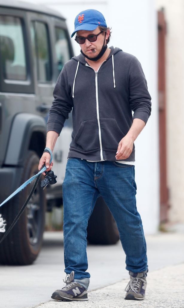 Home Improvement star Jonathan Taylor Thomas, 39, smokes a vape as he walks his two pet dogs in Hollywood