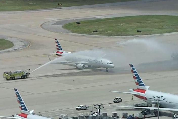 A plane carrying Elijah Snow&#39;s remains is saluted by firetrucks at Dallas-Fort Worth International Airport. (NBC5 DFW)