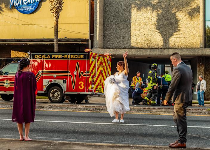 Marion County Sheriff&#39;s Corrections Officer Taylor Rafferty, center, directs traffic with her bouquet in hand as her future husband MCSO Deputy Christopher Rafferty, right, responded to a vehicle verses pedestrian accident while having their pictures take on the Ocala downtown square,  December 12, 2020 in Ocala, FL. &quot;I was using my bouquet to direct traffic,&quot; Taylor said while laughing Friday April 2, 2021.  [Wendy McCarthy Special to the Ocala Star Banner]2020